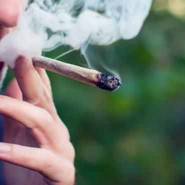 Man smokes a joint. Medical marijuana use and legalization of the cannabis, light drugs concept